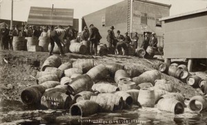 A police raid confiscating illegal alcohol, in Elk Lake, Canada, in 1925.